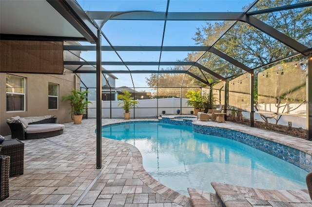 view of swimming pool with glass enclosure, a patio, outdoor lounge area, fence, and a pool with connected hot tub