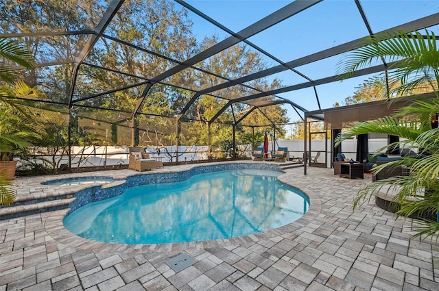 view of pool featuring glass enclosure, a patio, outdoor lounge area, fence, and a pool with connected hot tub