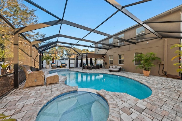 view of swimming pool with an outdoor living space, an in ground hot tub, a lanai, and a patio