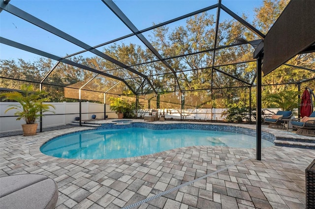 view of pool with a lanai, a fenced in pool, a patio, and an in ground hot tub