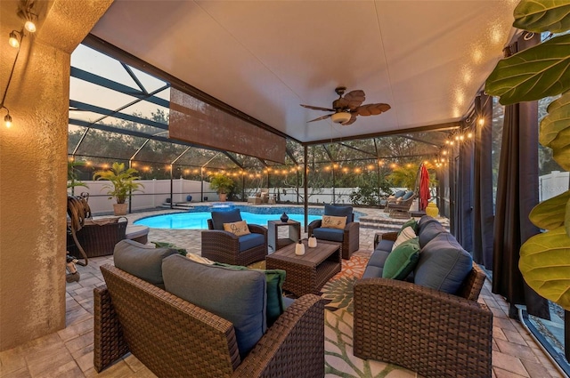 patio terrace at dusk featuring an outdoor living space, ceiling fan, a fenced in pool, and glass enclosure