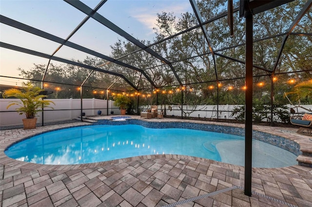 view of pool featuring a fenced in pool, a lanai, a patio area, and an in ground hot tub