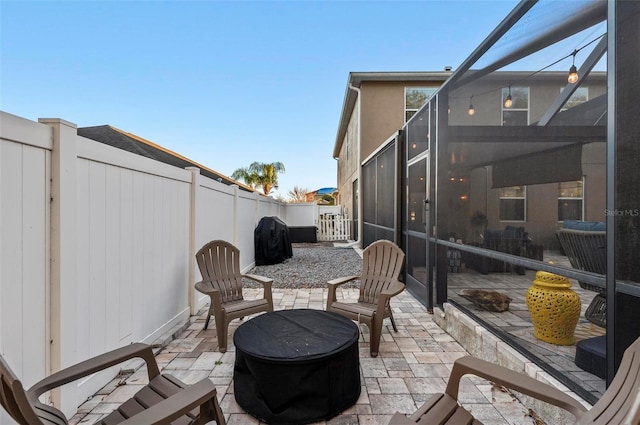 view of patio featuring a grill and a lanai