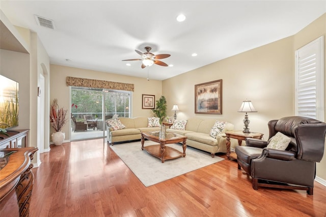 living room with hardwood / wood-style floors and ceiling fan