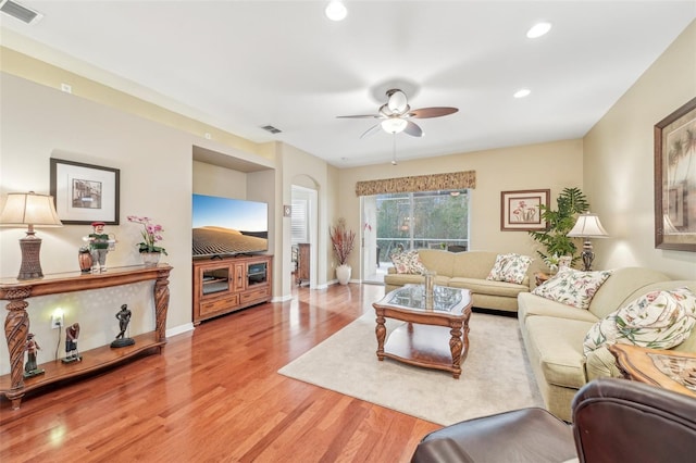 living room with wood-type flooring and ceiling fan