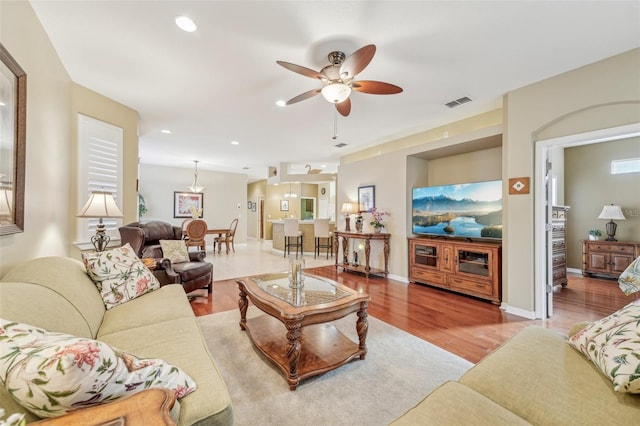 living room with ceiling fan and light hardwood / wood-style floors