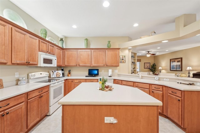 kitchen featuring light tile patterned flooring, white appliances, a center island, and kitchen peninsula