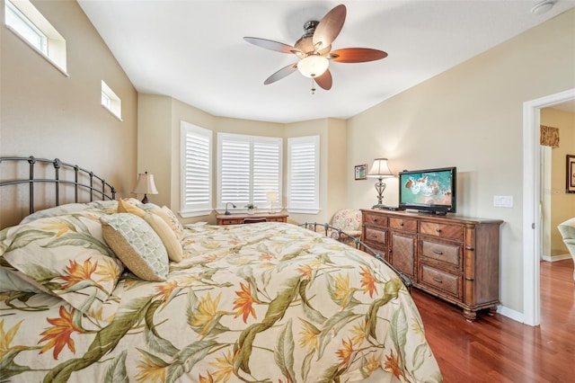 bedroom with dark hardwood / wood-style floors and ceiling fan