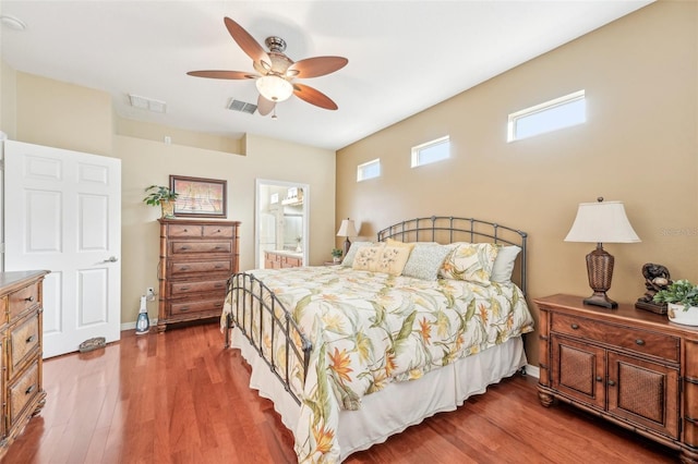 bedroom featuring wood-type flooring, connected bathroom, and ceiling fan