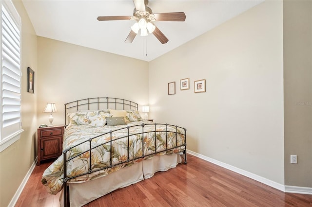 bedroom with hardwood / wood-style floors and ceiling fan