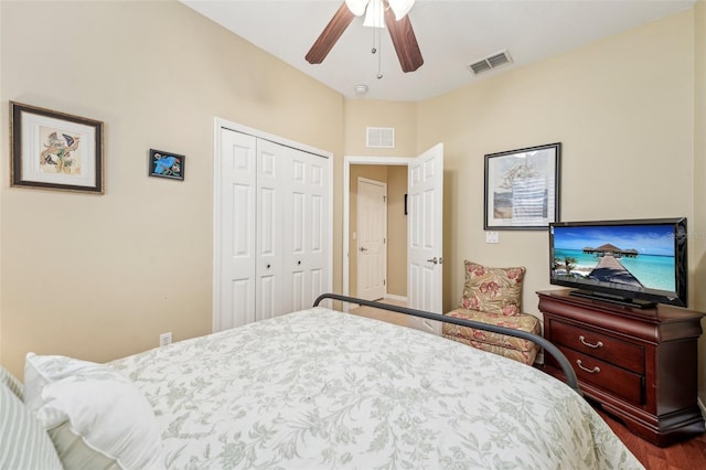 bedroom featuring wood-type flooring, ceiling fan, and a closet