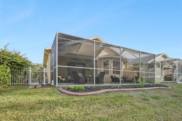 back of house with a patio, a lanai, ceiling fan, and a lawn