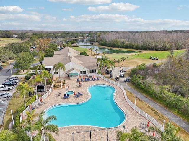 view of pool with a patio area and a water view