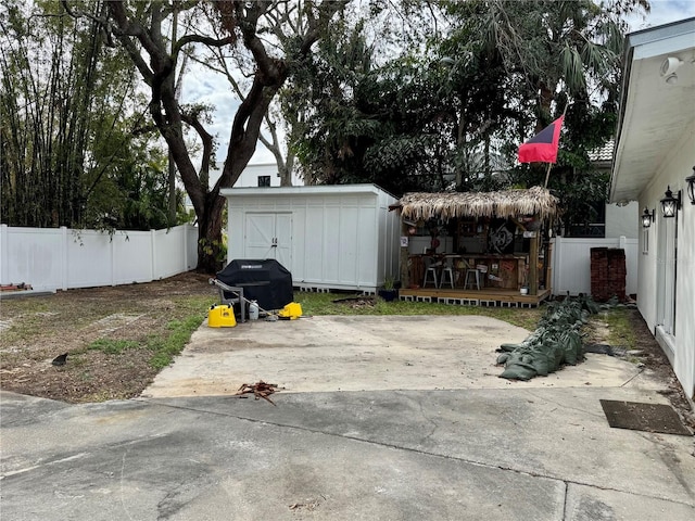 exterior space featuring a wooden deck, a grill, and a shed