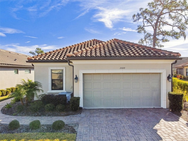 mediterranean / spanish house featuring a garage