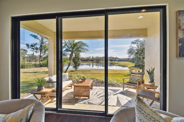 entryway with dark wood-type flooring and a water view