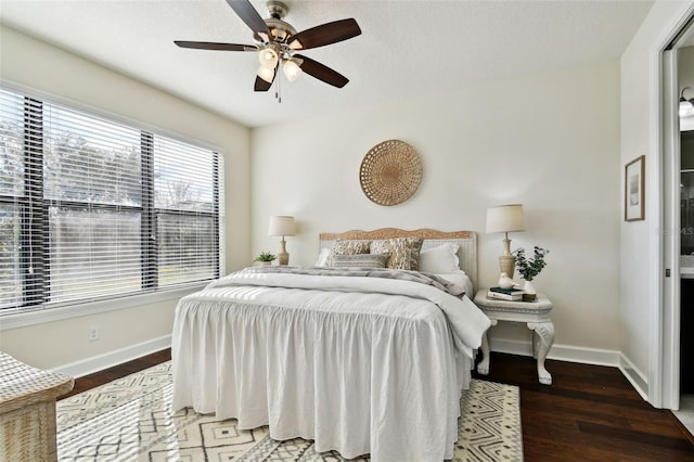 bedroom featuring ceiling fan, dark hardwood / wood-style flooring, and a textured ceiling