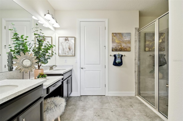 bathroom featuring vanity and an enclosed shower