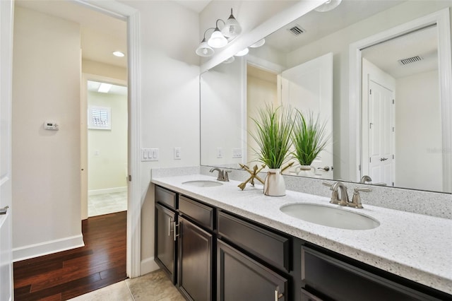 bathroom with vanity and hardwood / wood-style floors