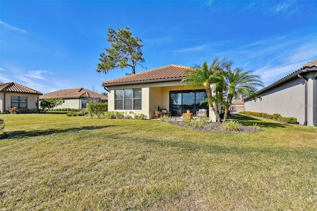 rear view of property with a lawn