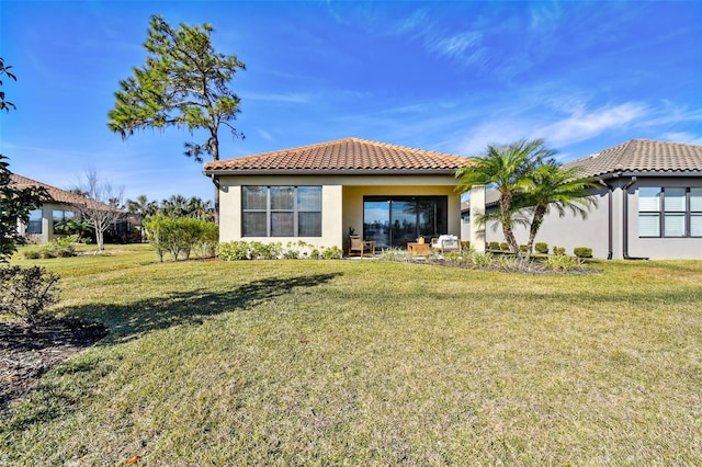 back of property featuring a lawn