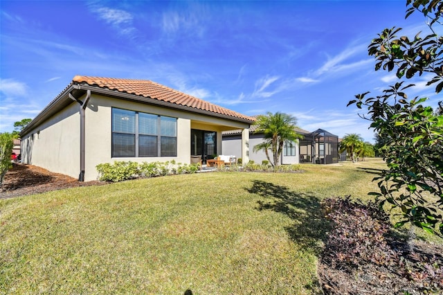 back of property featuring a yard and a lanai