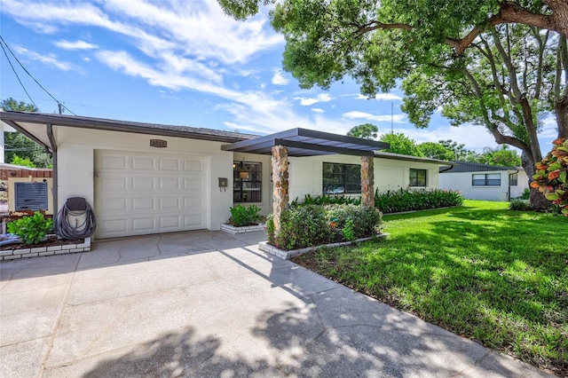 ranch-style house featuring a garage and a front yard