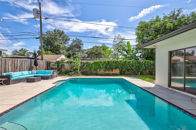 view of pool featuring outdoor lounge area and a patio