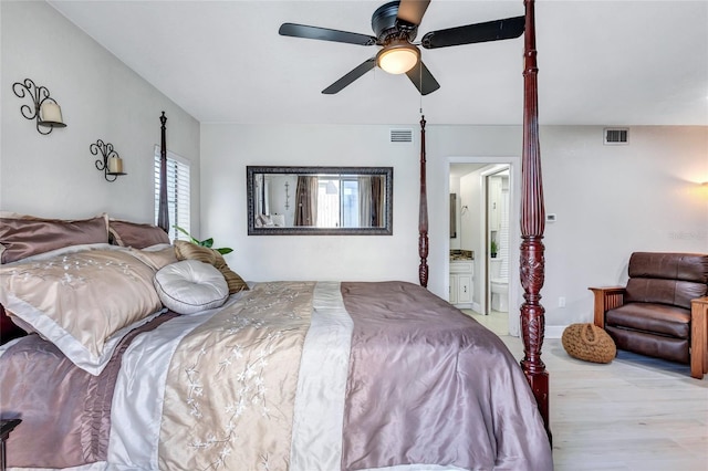 bedroom with ensuite bathroom, light wood-type flooring, and ceiling fan