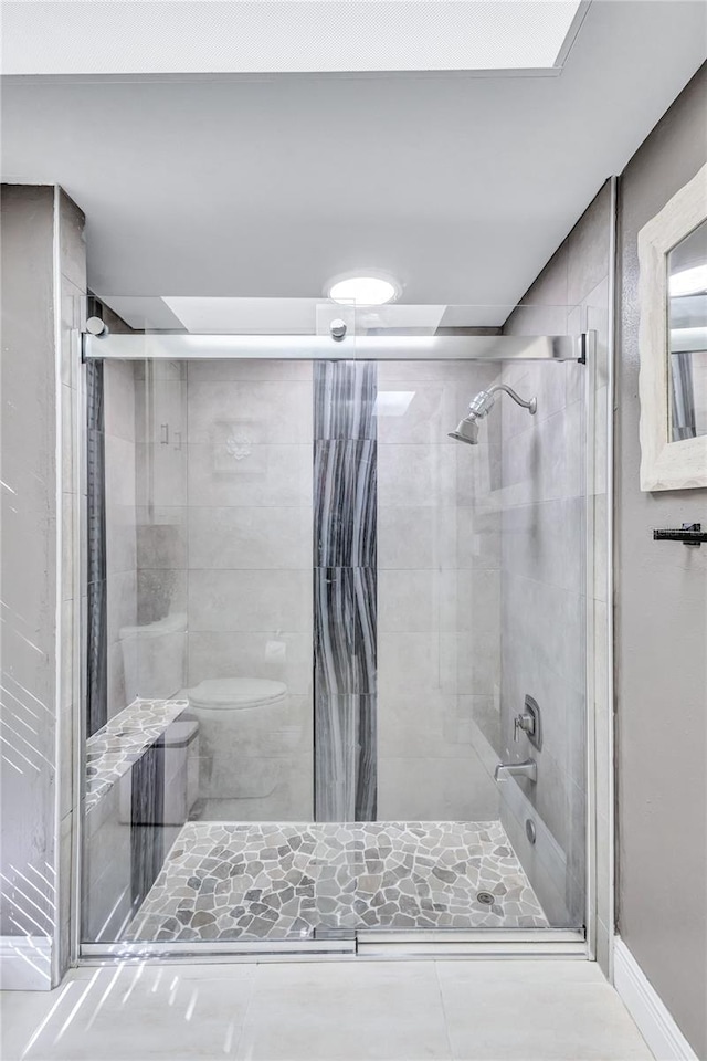 bathroom featuring walk in shower and toilet