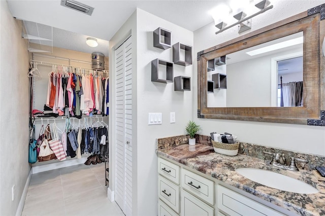 bathroom with vanity and tile patterned flooring