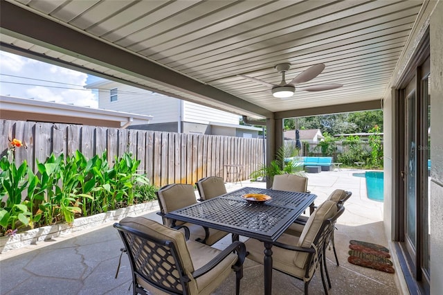 view of patio / terrace featuring a fenced in pool and ceiling fan