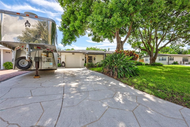 view of front of property with a garage and a front yard