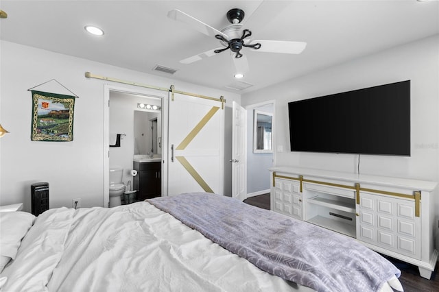 1203 Desmond St, Port Charlotte, FL 33952 - bedroom featuring dark wood-type flooring, recessed lighting, visible vents, and a barn door