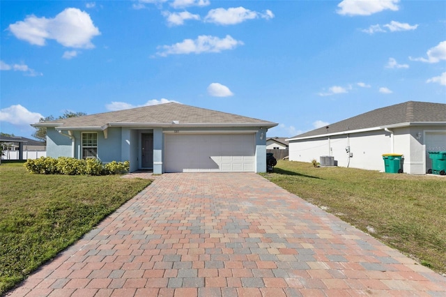 1203 Desmond St, Port Charlotte, FL 33952 - ranch-style home featuring decorative driveway, stucco siding, a front yard, central AC, and a garage