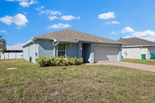 1203 Desmond St, Port Charlotte, FL 33952 - ranch-style home with stucco siding, an attached garage, fence, decorative driveway, and a front yard