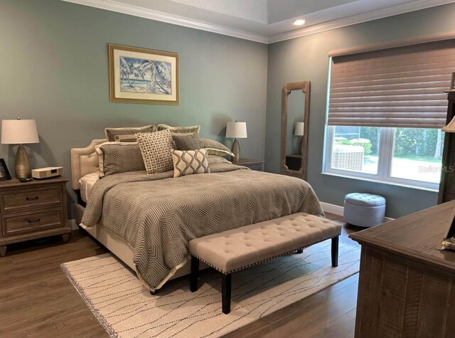 bedroom featuring crown molding and dark wood-type flooring