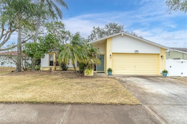 ranch-style house with a garage and a front yard