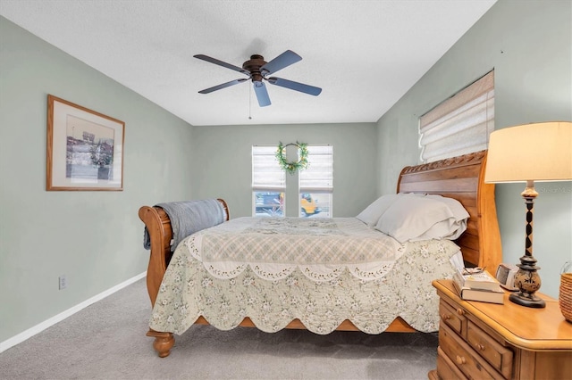 carpeted bedroom featuring a textured ceiling and ceiling fan