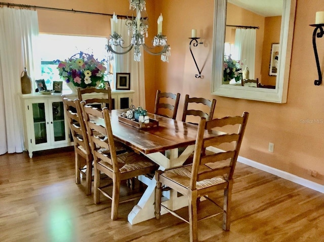 dining room featuring hardwood / wood-style floors and a chandelier