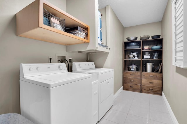 washroom featuring light tile patterned floors and washer and dryer