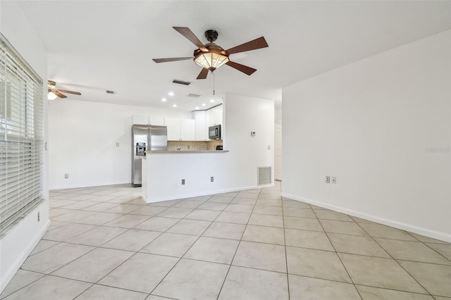 unfurnished living room with light tile patterned floors and ceiling fan