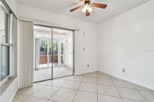 tiled empty room with ceiling fan