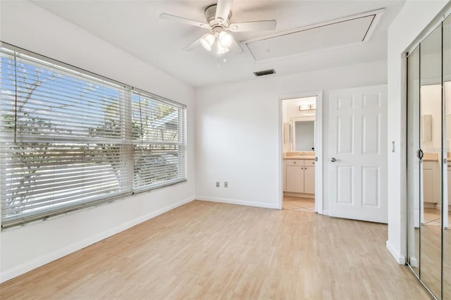 unfurnished bedroom with ceiling fan, sink, light hardwood / wood-style floors, and ensuite bath