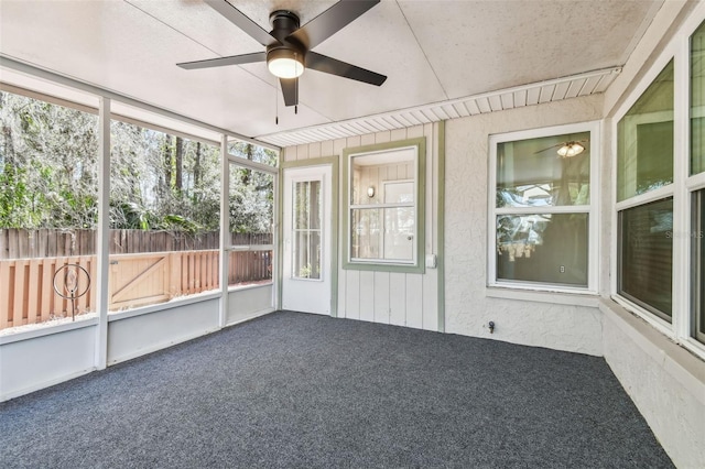 unfurnished sunroom with ceiling fan