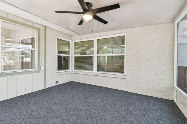 unfurnished sunroom with ceiling fan