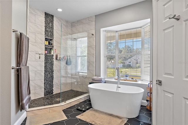 bathroom featuring tile patterned flooring and shower with separate bathtub