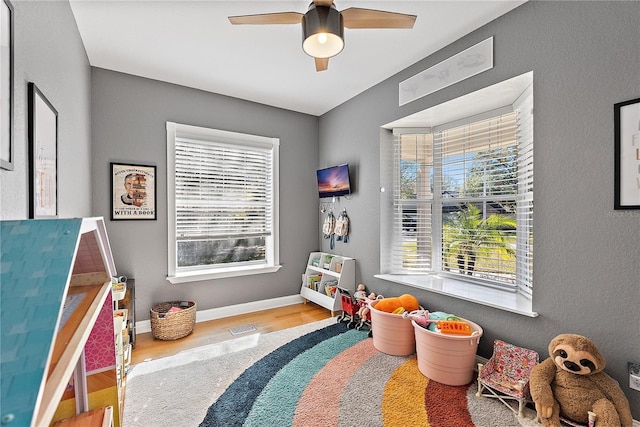 game room featuring wood-type flooring and ceiling fan