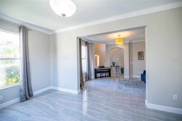 empty room with crown molding and a wealth of natural light