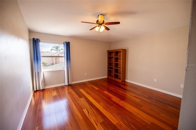 empty room featuring dark wood-type flooring and ceiling fan